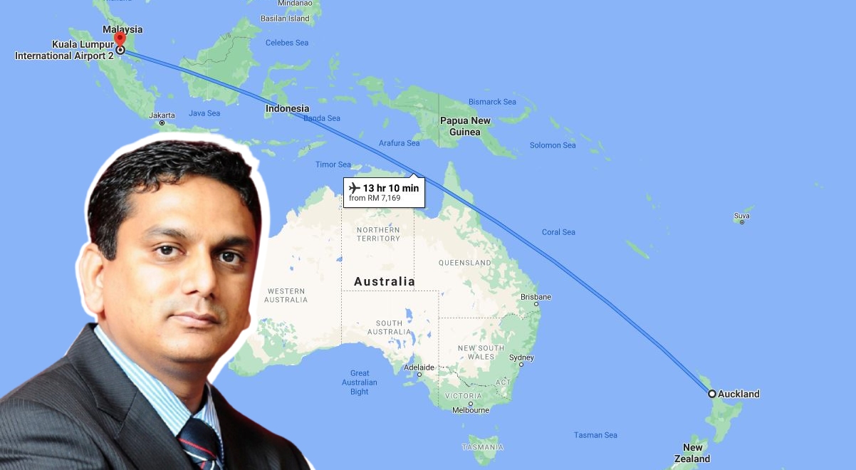 Photo of Edmund Santhara against a New Zealand to KL flight map. Photo: Coconuts
