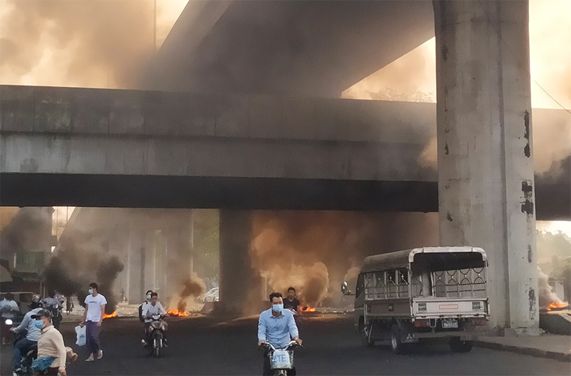 Fires continued to burn Monday morning in Yangon’s Hlaing Thar Yar Township. Photo: Yu San Kyi