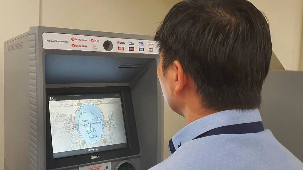A man testing out the face recognition feature at an OCBC ATM. Photo: OCBC
