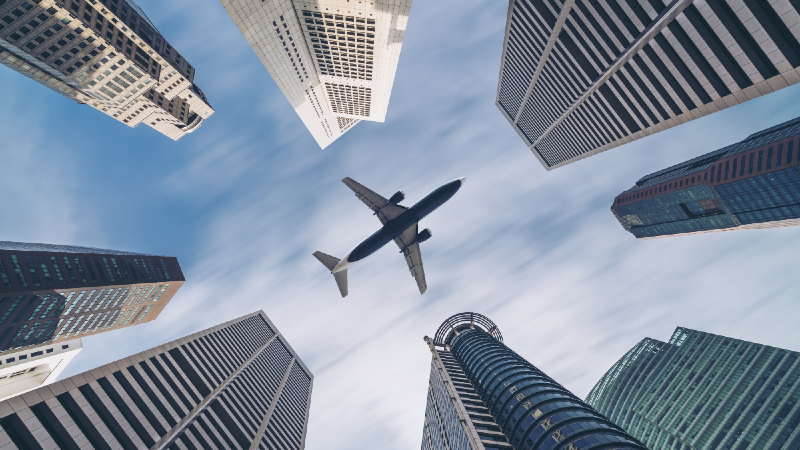 File photo of a plane flying over Singapore’s skyline buildings.

