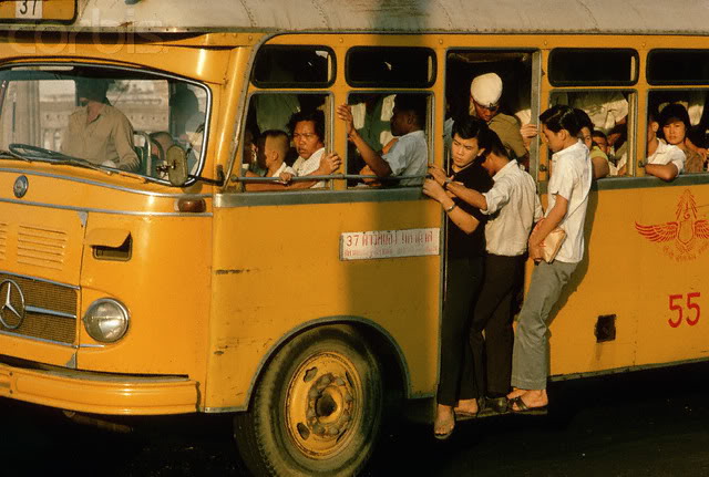 A historic photo of people boarding a Bangkok bus from the old days. The photo’s origins are unknown.
