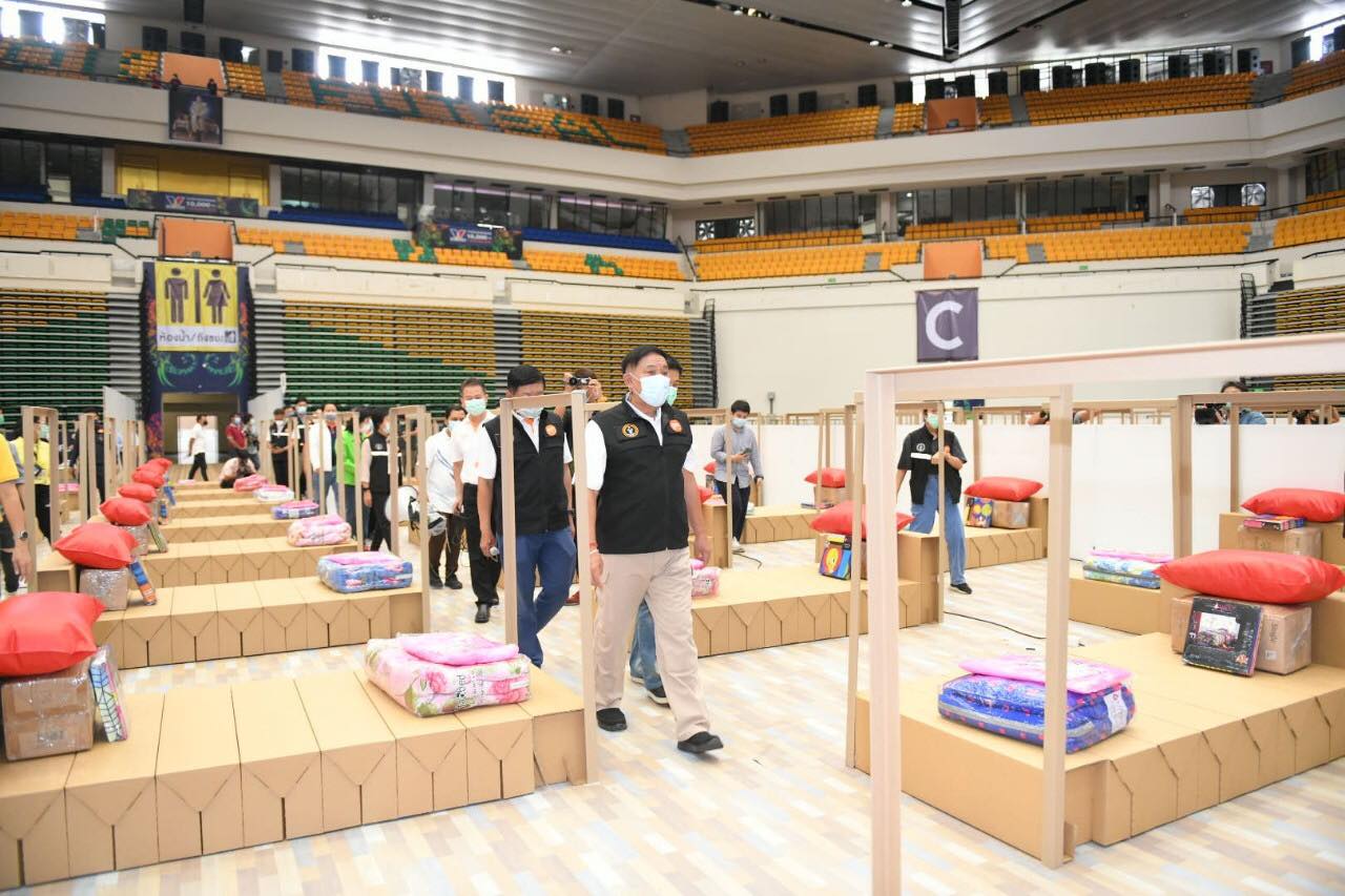 Cardboard boxes were made into makeshift beds for COVID-19 patients Sunday at the Bangkok Arena Sports Center. Photo: BMA