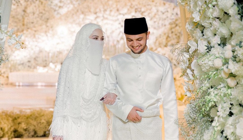 Neelofa, at left, and PU Riz, at right walking down the aisle on their wedding day. Photo: Neelofa/Instagram