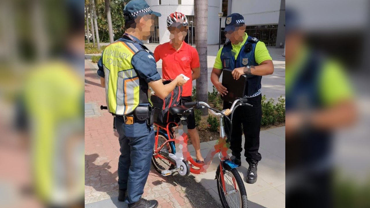 Transport officers question an e-bike rider in a February 2020 file photo. Photo: LTA