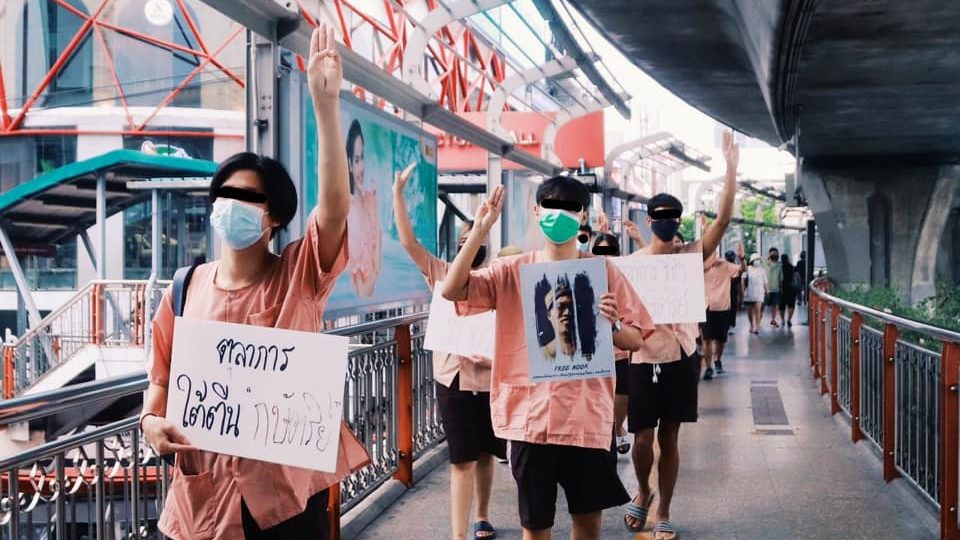 Activists dressed as prison inmates walk on a Bangkok skywalk to protest the Thai justice system. Photo: United Front of Thammasat and Demonstration / Facebook
