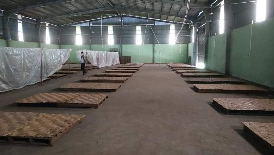 A new COVID-19 quarantine facility, featuring bamboo mats for beds, being set up in Yangon. Photo: Facebook