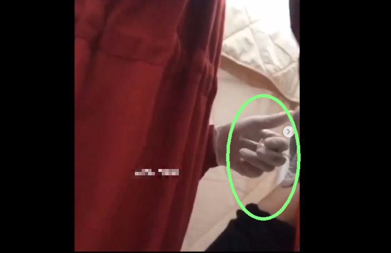 Screengrab from a video purportedly showing a vaccinator holding back on pressing the syringe plunger when administering a COVID-19 jab. 