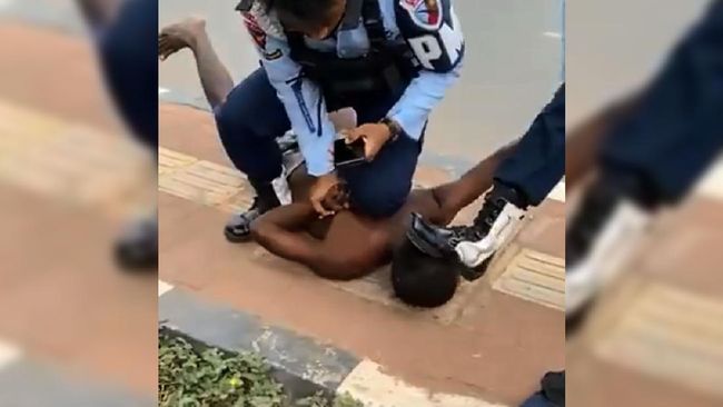 Screengrab from the now-viral video, which shows two officers from the Indonesian Air Force using excessive force against a Papuan man. 