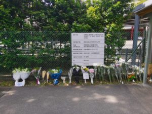 Bouquets of flowers and letters placed outside the school’s entrance. Photo: Natsham