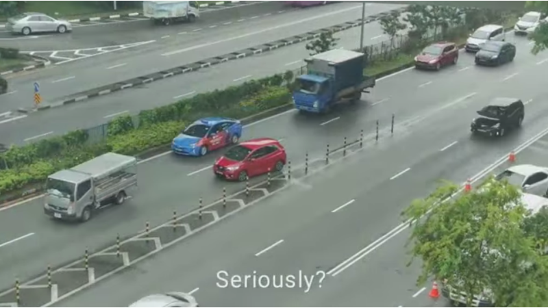 Screenshot from the video showing the red car reserving on Braddell road. Photo: Dzulkarnean Mosbah/Facebook

