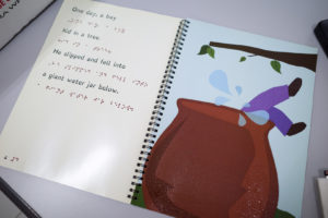 A braille book with textured diagrams. Photo: Coconuts