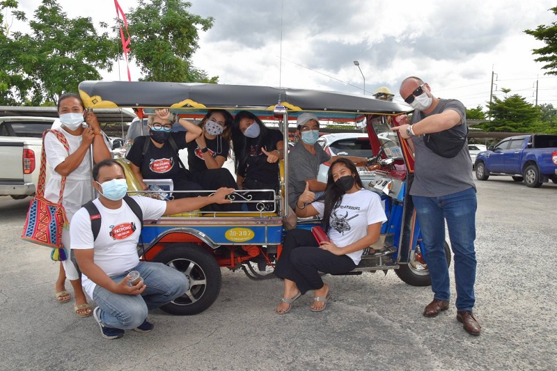 Patpong venue owner Michael Messner, far right, along with employees and other people informally employed in Patpong on their way to get vaccinated last month.