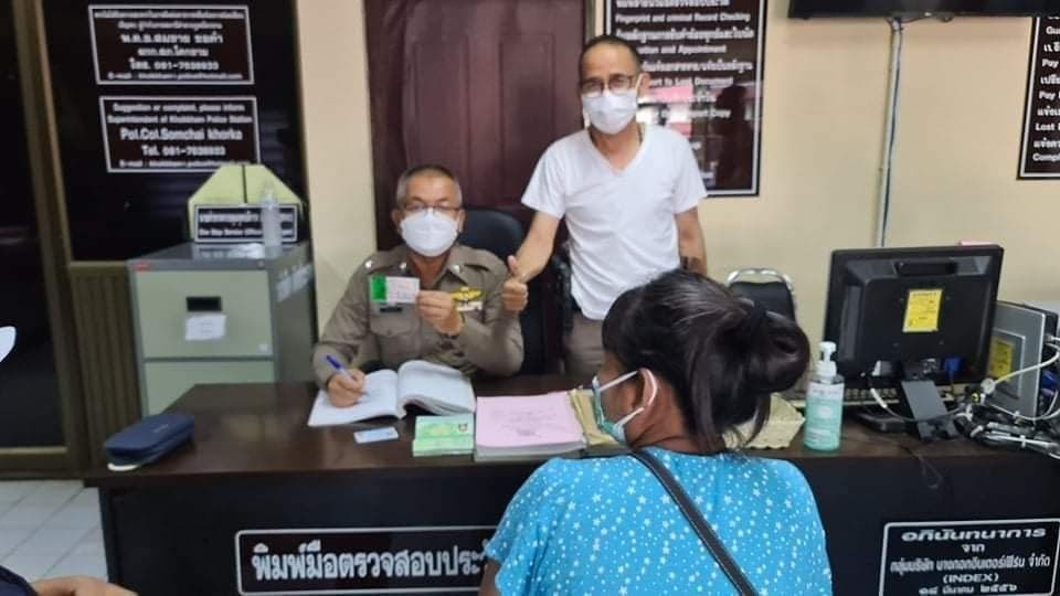 An ethnic Karen woman gets help from Khine Gyi, director of AAC Thailand, in processing her large lottery jackpot at a police station in northern metro Bangkok. Photo: Ye Min Oo