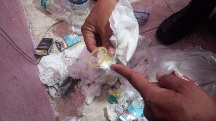 An unwrapped condom found in a room where two Public Order Agency (Satpol PP) officers were caught naked with a sex worker. Photo: Istimewa