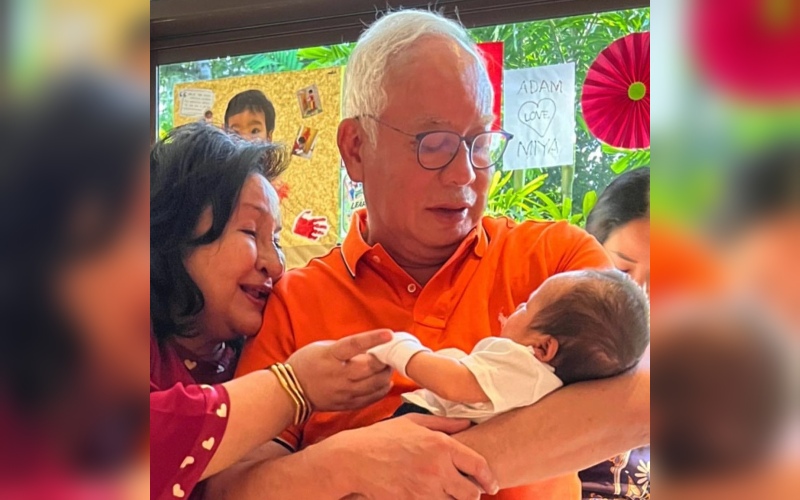 Najib and Rosmah holding baby Aidan Najib in their arms yesterday. Photo: Yana Najib
