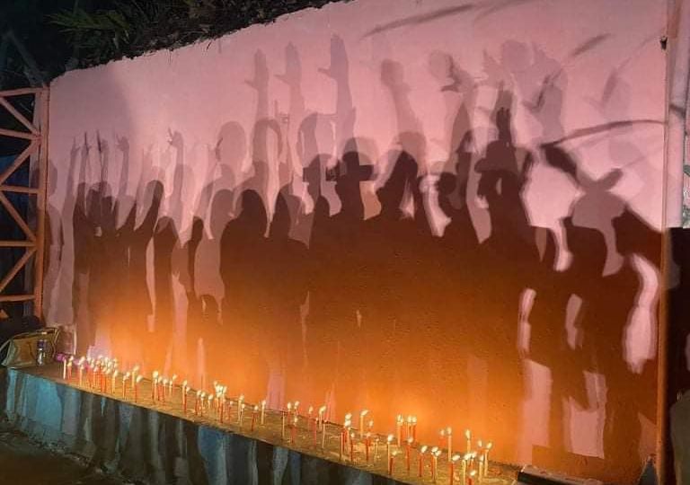 Youths reclaimed the wall and cast their shadows in the evening in an emotional candle-lighting ceremony after COMELEC personnel took down their mural. Image: Isabela for Leni-Kiko (Facebook)