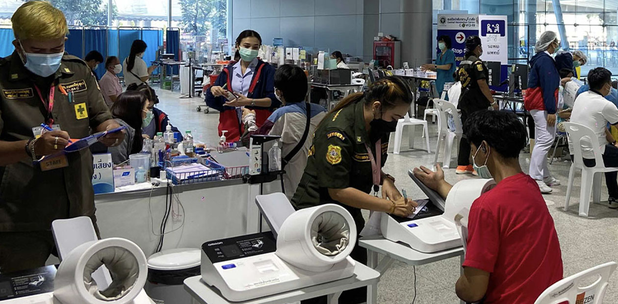 Health care workers administer vaccines last month at Bangkok’s Bang Sue Grand Station. Photo: Coconuts