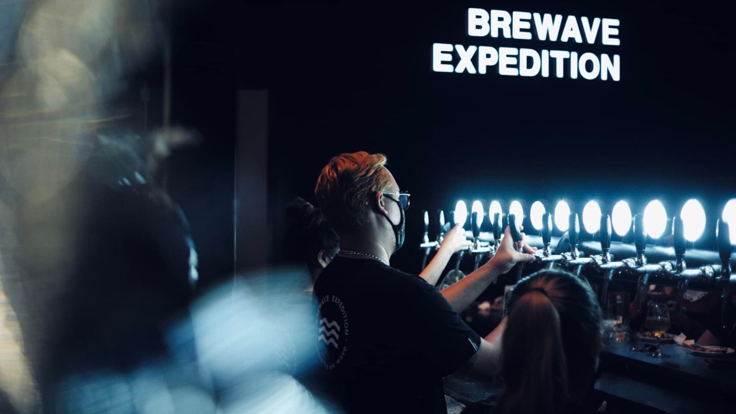 A staff at Brewave brewpub in Bangkok dispenses craft beer from taps. 
