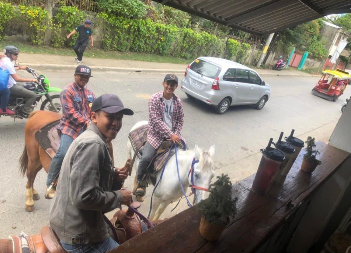 Horsemen in Malaybalay, Bukidnon buy milk tea on horseback amid soaring fuel prices. Photo by Katrina Cudal Hernandez
