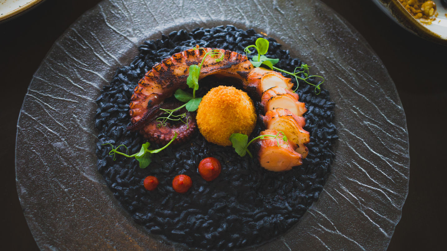 The Al Nero (S$32), a black ink risotto with grilled octopus, crispy pumpkin croquette and spicy harissa paste. Photo: Carolyn Teo/Coconuts
