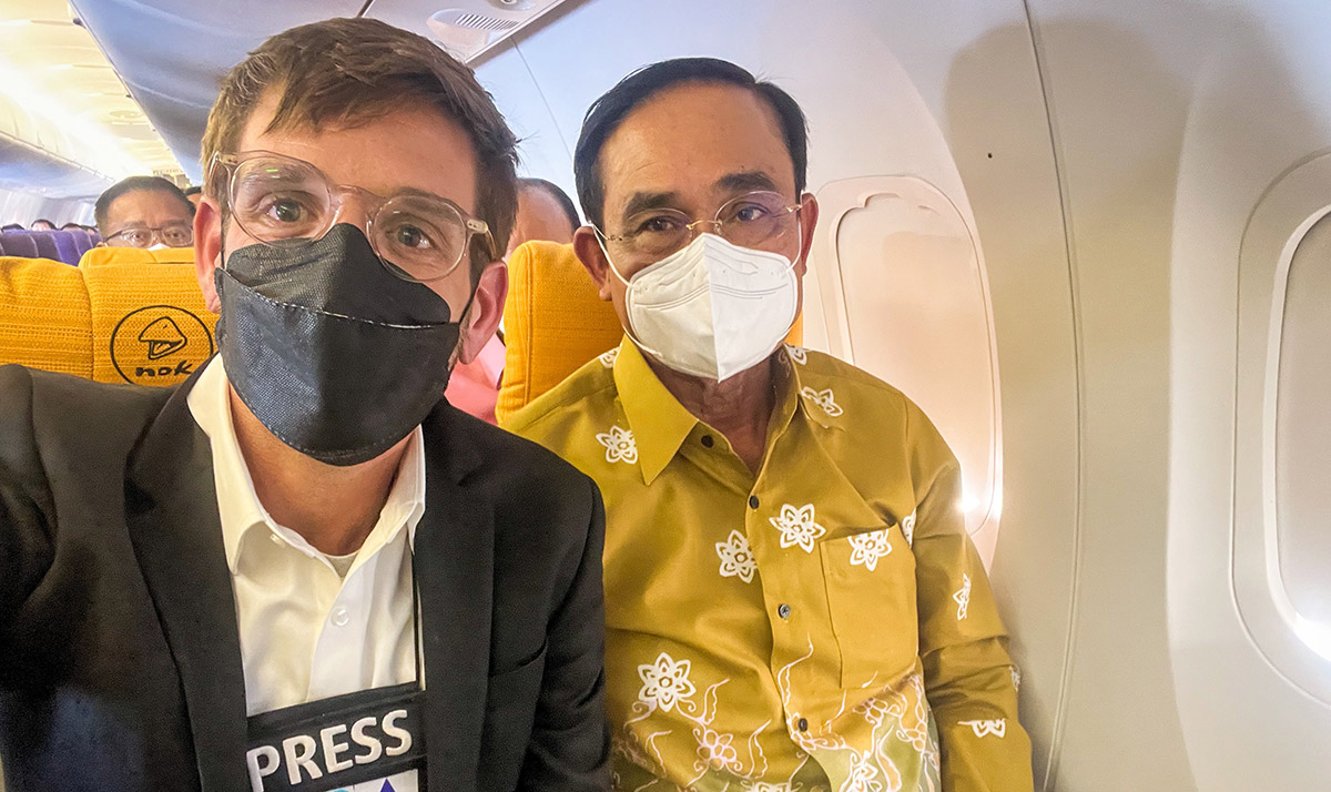 American photojournalist Matt Hunt sits beside Prime Minister Prayuth Chan-ocha in a photo he tweeted from a March 14 press event. Photo: Matt Hunt / Twitter
