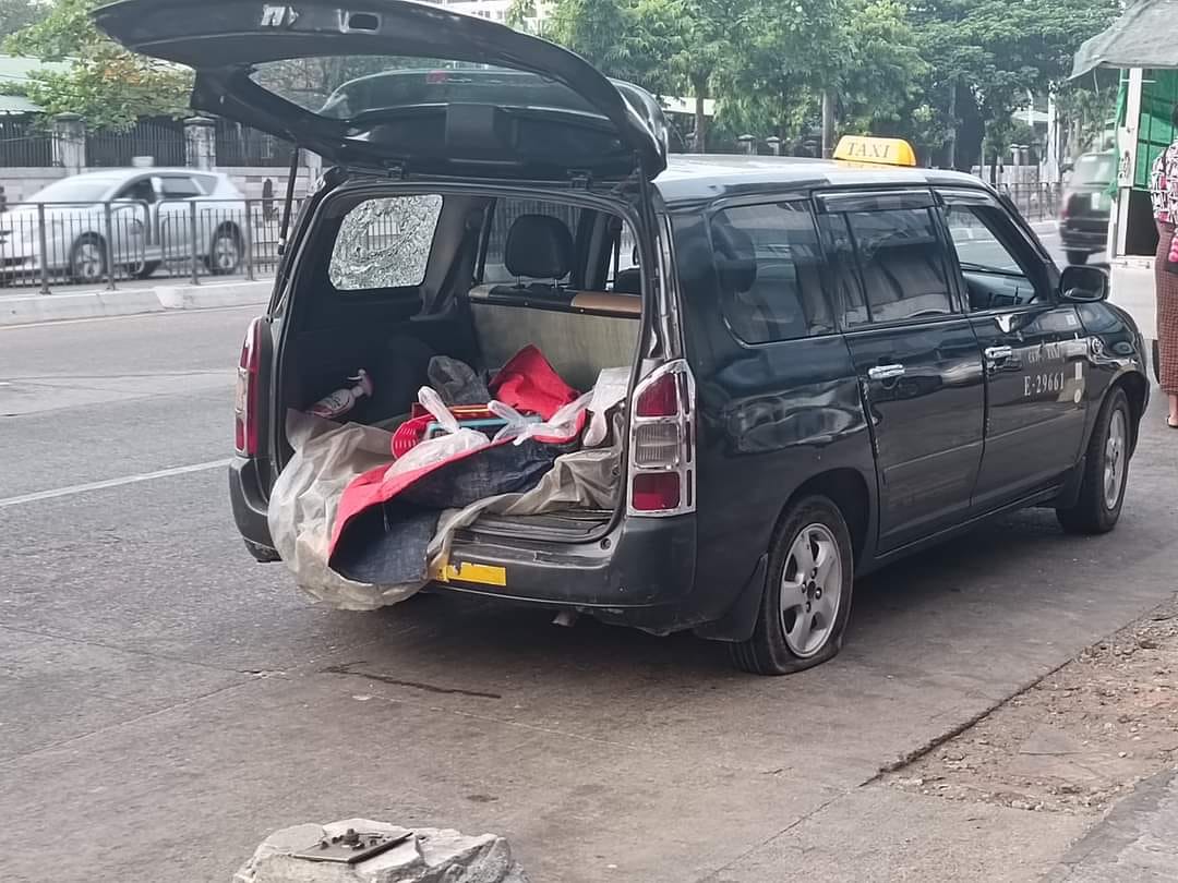 A young man was killed Thursday morning in this bullet-ridden taxi in Kamayut Township. Photo: Nyan Lin Phyo / Facebook