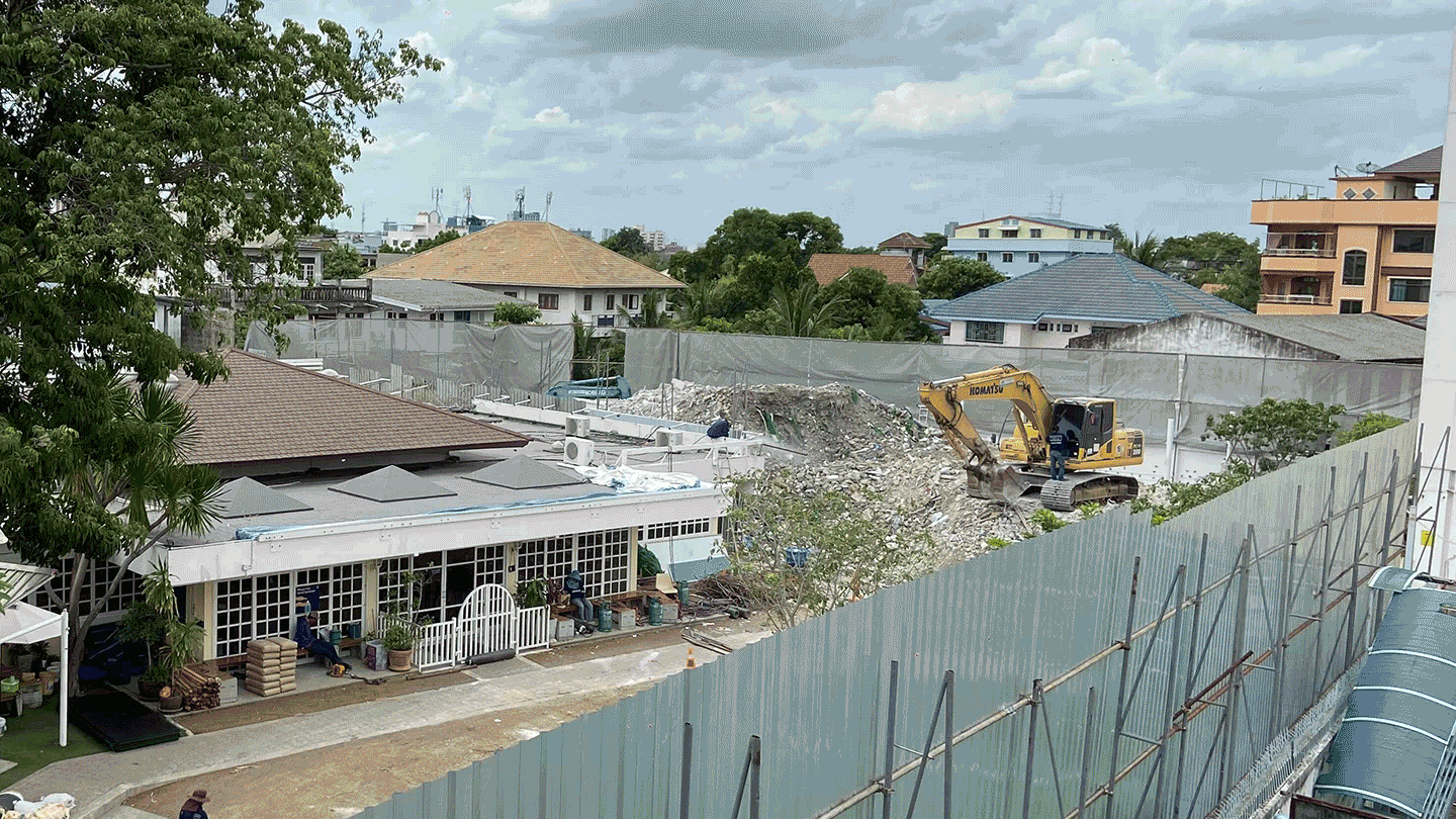 Last month, workers removed a lawn that encroached on public land behind St. Andrews International School, and the same view from Wednesday after demolition of the building was completed. Photos: Nicky Tanskul