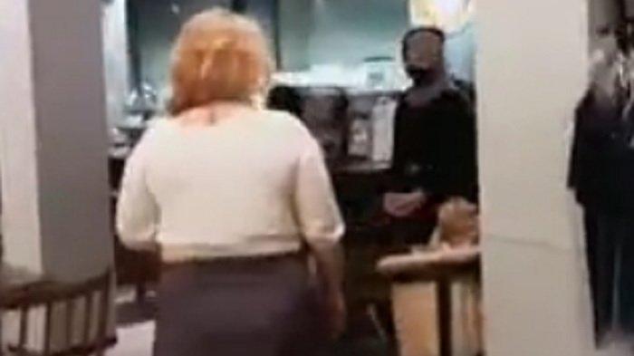 Video screengrab showing a lady berating café employees after the shop was closing and she was asked to leave.