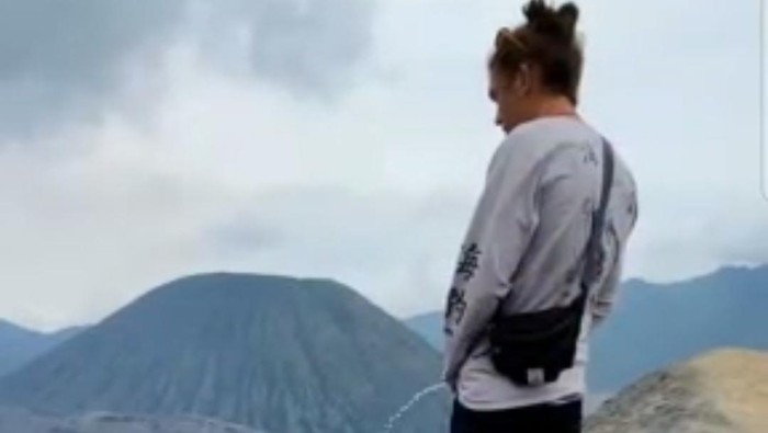 Screengrab from a video showing a European tourist peeing on the sacred Mount Bromo in East Java, Indonesia.