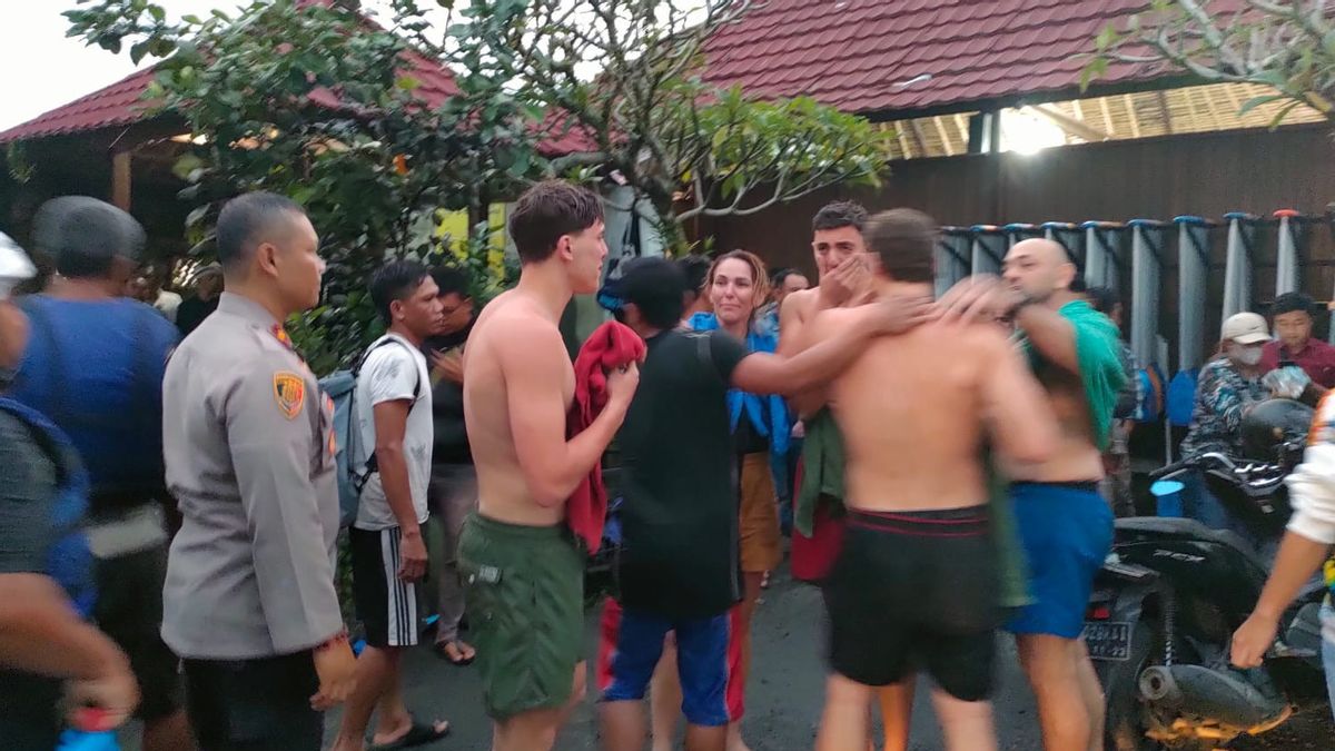 Survivors of a rafting accident in Ubud on Oct. 3, 2022, comforted each other after being rescued. One of them, an American man, was still missing per this picture’s publication. Photo: Ubud Police.