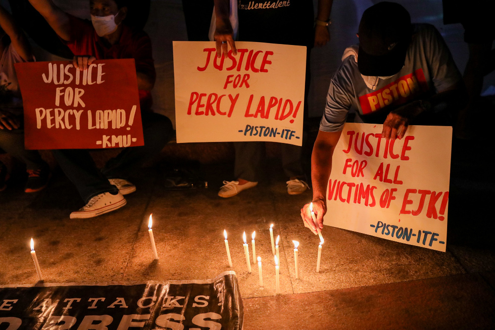 Members of various media organizations and human rights activists light candles and carry signs condemning the murder of broadcast journalist Percival Mabasa, more popularly known as Percy Lapid, during an indignation rally in Quezon City, Metro Manila, Philippines. October 4, 2022. Percival, who was a staunch critic of the Duterte and Marcos administration, was killed on Monday by two  assailants riding on a motorcycle, according to reports. Photo: Basilio Sepe/BenarNews