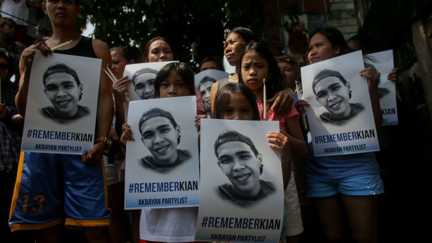 Relatives, friends, and supporters of Kian Loyd delos Santos hold placards in his memory on the first anniversary of the Filipino teenager’s killing in Caloocan City, Metro Manila, Aug. 15, 2018. Photo: Basilio Sepe/BenarNews