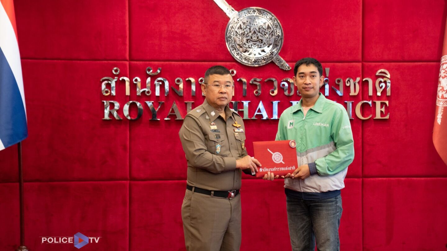 Peeraphong Chumphonwadee is presented a certificate honoring his bravery on Tuesday in metro Bangkok. Photo: Royal Thai Police