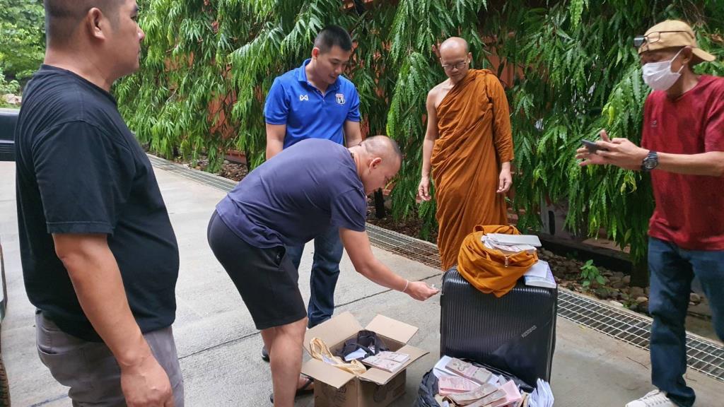 Police search the belongings of former temple abbot Khom Apirawaro. Photo: Nakhon Ratchasima Police